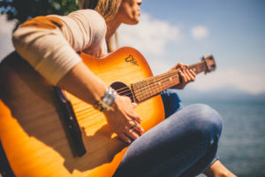 success as a music artist, girl playing guitar
