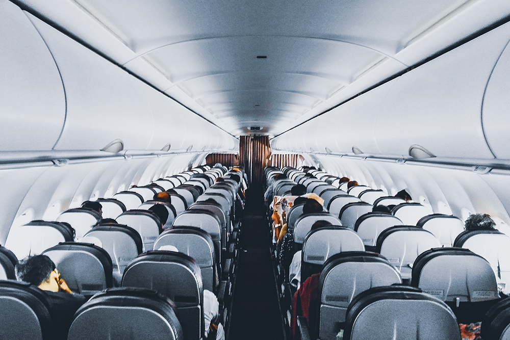 Why Being Lost Is So Good for You, image of the inside of an airplane seating and people in the seats