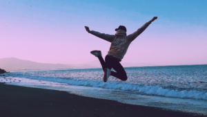 pandering vs not pandering, image of a guy jumping during a sunset at the beach