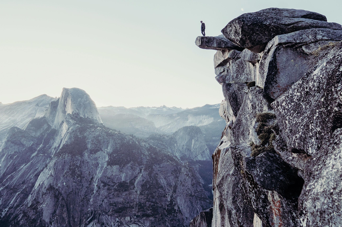Overconfident + Incompetent = Successful?, image of a person standing on the edge of a cliff